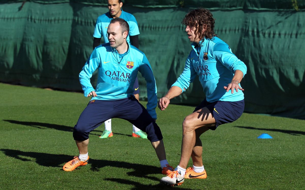 Iniesta and Puyol train with the rest of the squad
