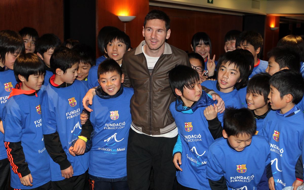 Messi meets a group of youngsters affected by the tsunami in Japan in 2011